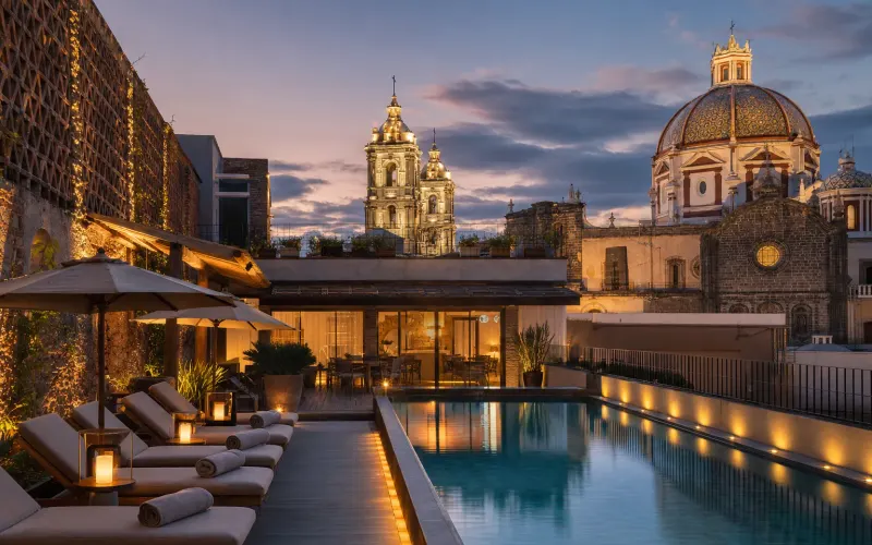 AI-generated editorial dusk view of Cartesiano Boutique & Wellness Hotel in Puebla, Mexico